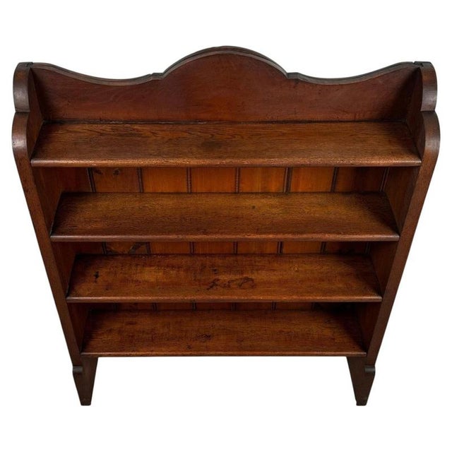 A handsome early 20th-century English open bookcase, finely constructed from oak and distinguished by its restrained...