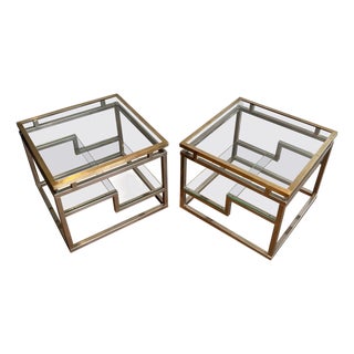 Pair of designer side tables in chrome, brass and glass. French work. Circa 1970. For Sale