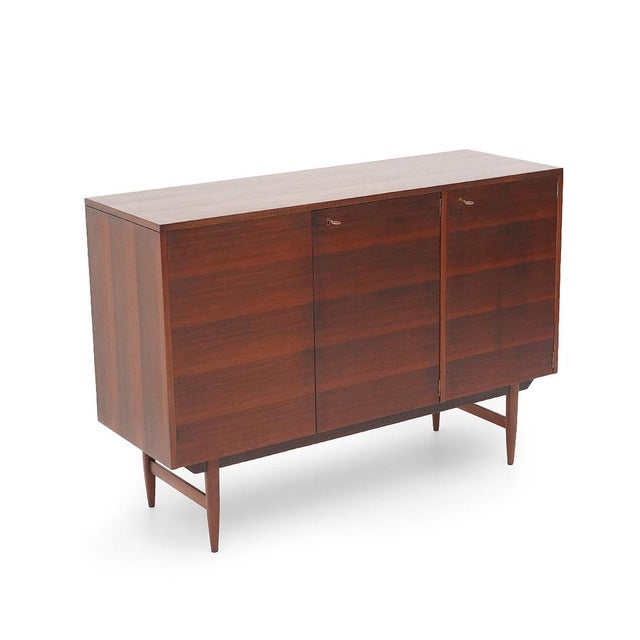 Elegant Italian sideboard from the 1950s, crafted in mahogany veneer and defined by a balanced, restrained composition...