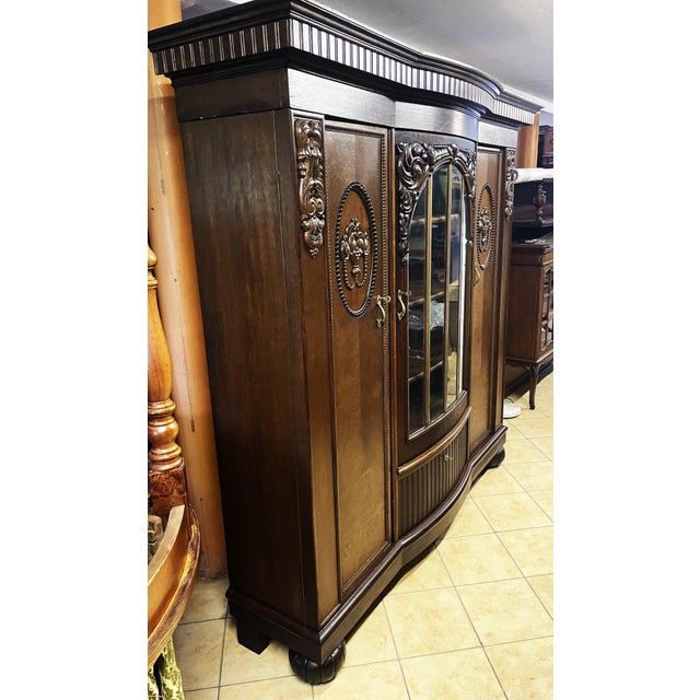 A study bookcase crafted in the early 20th century, representing the pinnacle of European cabinetmaking from the late...