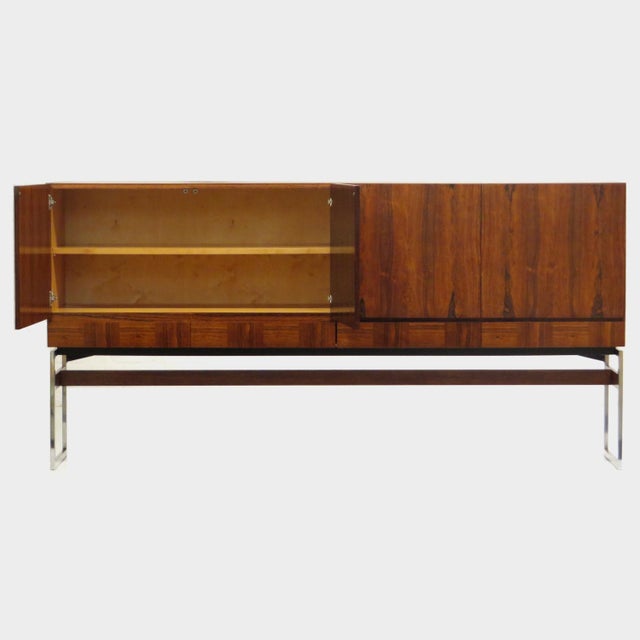 Vintage mid century modern design sideboard with four drawers, crafted in rosewood, from the 1960s. The sideboard rests on...