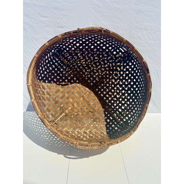 This striking antique split bamboo gathering basket is a beautiful example of functional craftsmanship rooted in...