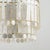 Gorgeous layers of Capiz shell, in alternating circles and rectangles, dangle from an Aged Brass frame for a sophisticated...