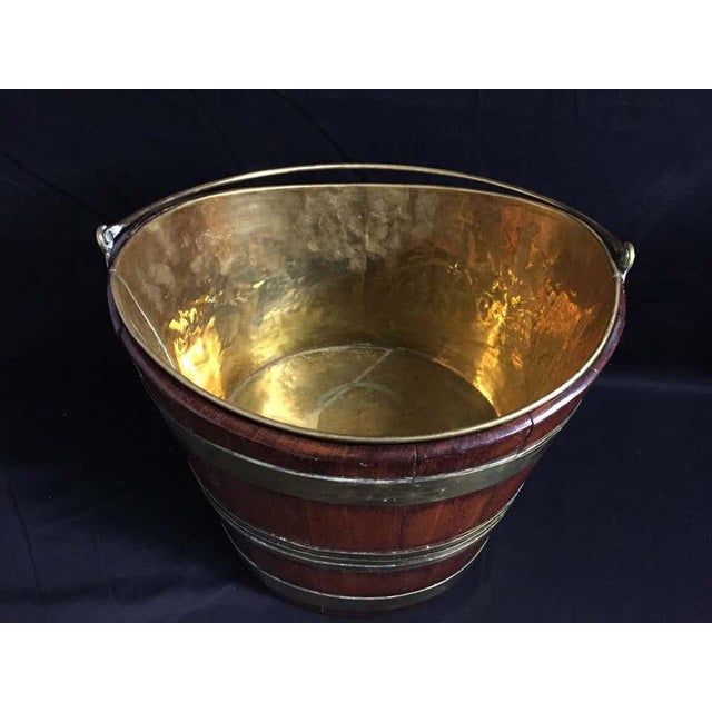 A stunning 18th century mahogany and brass bound wine cooler, the cooler has a brass carrying handle and removable brass...