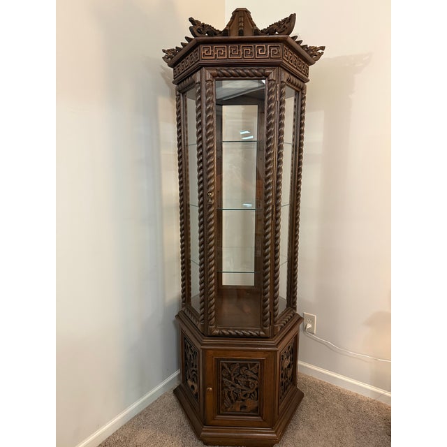 An exceptional and striking mid-20th century Chinoiserie pagoda vitrine / curio cabinet, rendered in deeply patinated...