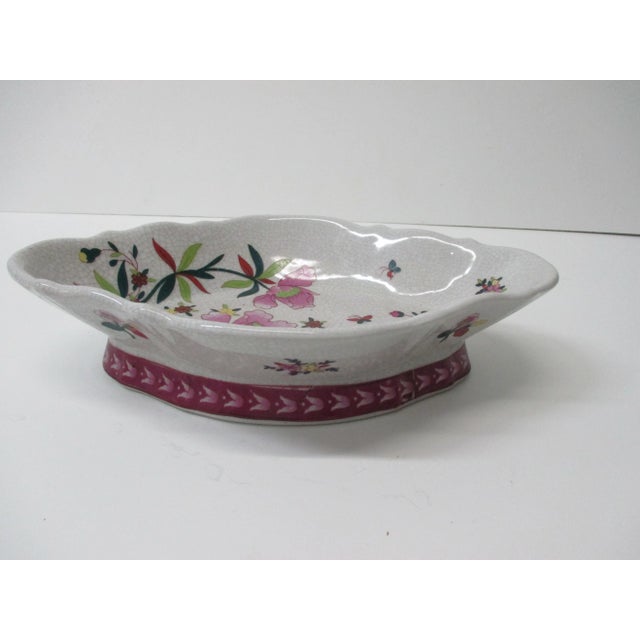 Large Chinese Export catchall oval decorative dish. Depicting flowers and crackled porcelain finish. Size: 11" L x 7.5" W...