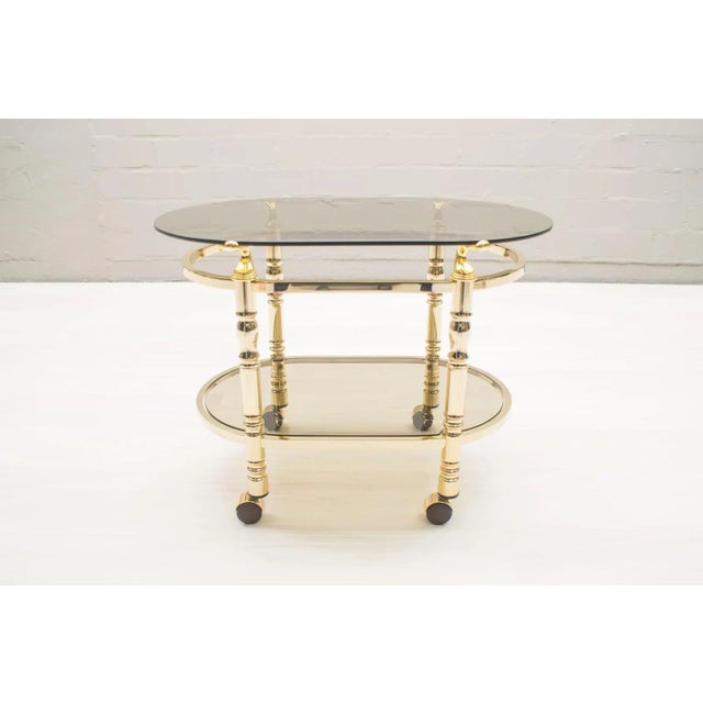 Hollywood Regency Brass & Smoked Glass Serving Trolley, 1960s, in Very Good conditions. Designed 1960 to 1969