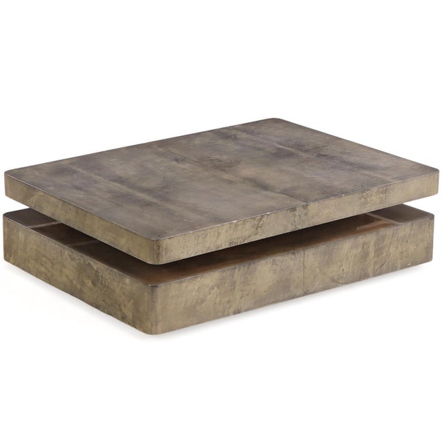 Attributed to Aldo Tura, this lacquered goatskin coffee table features a richly textured finish and a sliding mechanism...