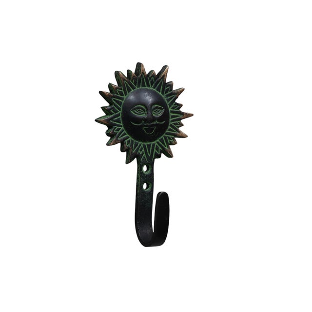 A set of four bohemian sun green brass wall hooks. Each is topped with a sunburst with lines framing the rays and...