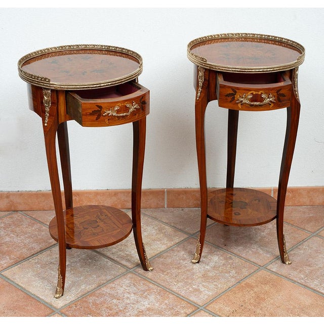 Pair of antique Napoleon III side tables in fine exotic woods with gilt bronze applications. The circular top features a...