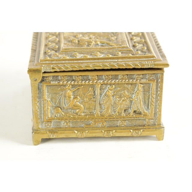 A handsome 19th century Continental brass casket, richly decorated in repousse with neoclassical figural scenes across all...