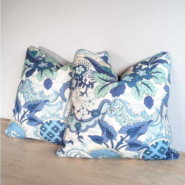 Harlequin Shenlong indoor/outdoor performance pillows in celeste/ink colorway, with coordinating navy perennials backs and...