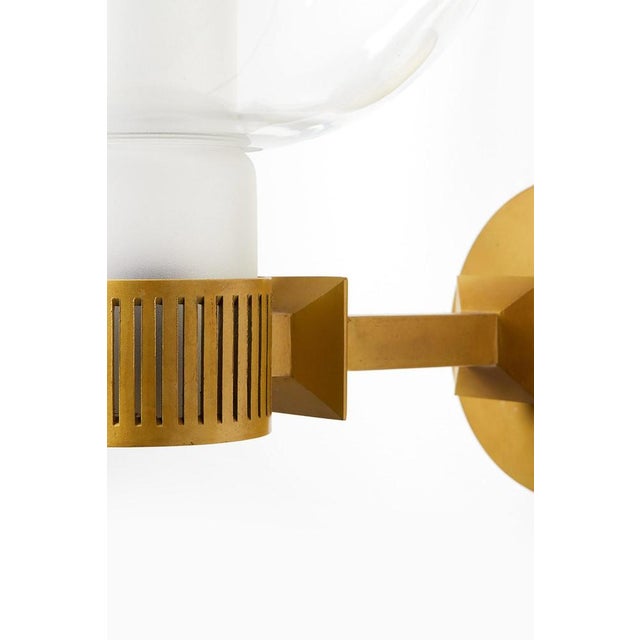 This rare set of wall lamps, produced in sweden during the 1950s, represents a sophisticated example of custom...