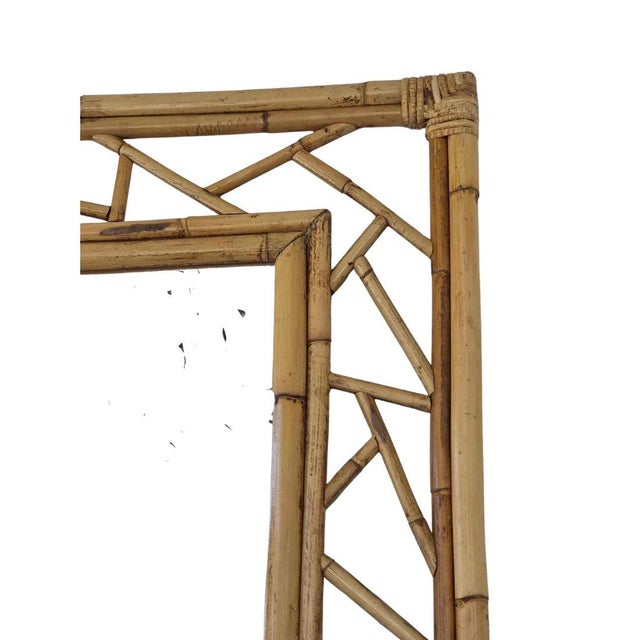 Vintage handcrafted rattan and bamboo wall mirror featuring an artistic open lattice frame. The natural finish and clean...