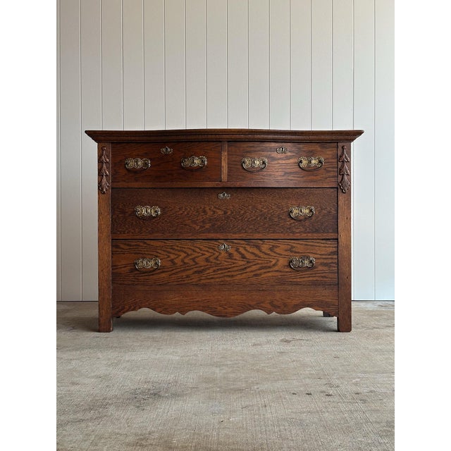 A handsome turn-of-the-century oak chest of drawers showcasing the rich figuring and craftsmanship that made American...