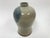 A well crafted Pottery Vase in bottle form in Asian style. The Vase with a natural lightly ribbed body and narrow neck...