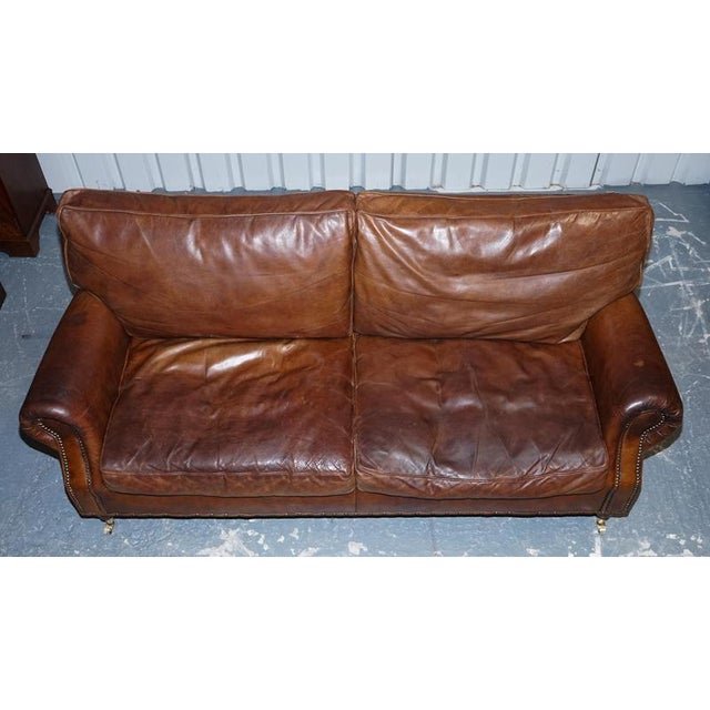 This striking Balmoral three seater sofa by Halo, in the style of Timothy Oulton, combines classic Chesterfield design...