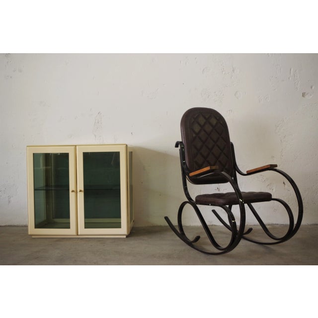 Rocking chair with dark brown lacquered iron frame, teak wood arms, brown leather seat and back 1950s.
