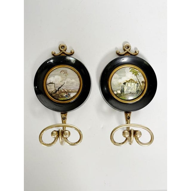 Pair of painted wood and brass wall hooks, France, 19th century. An elegant pair of turned wood and brass wall hooks,...