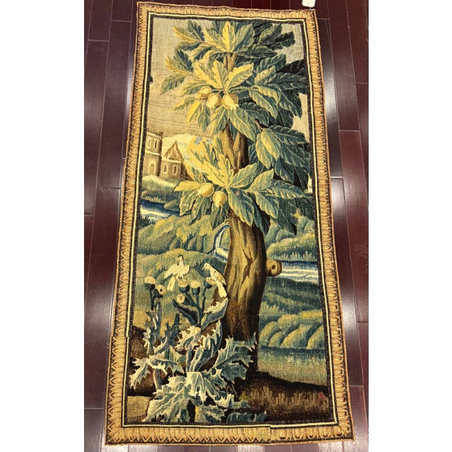 An authentic 17th century Flemish tapestry depicting a serene pastoral landscape rendered in the traditional pictorial...