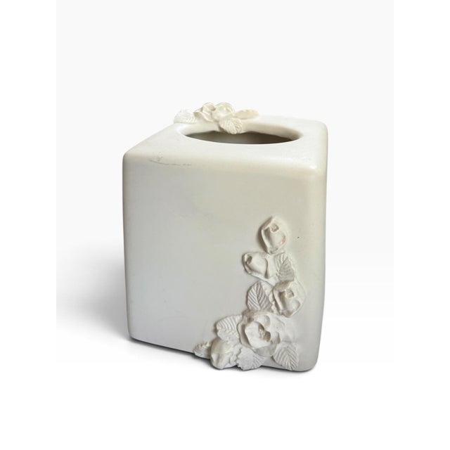 Elegant and sculptural white ceramic tissue box cover featuring a minimalist square silhouette accented by dimensional,...