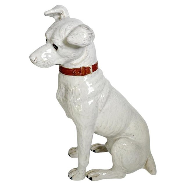 Charming French ceramic sculpture dating from the 1970s, depicting a seated dog with an attentive and expressive posture....
