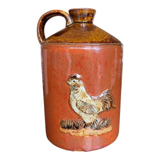 Mid 20th Century Vintage Stoneware Ceramic Two-Toned Gloss Glazed Red & Brown Whiskey Jug Rooster Relief Motif Farmhouse Country For Sale