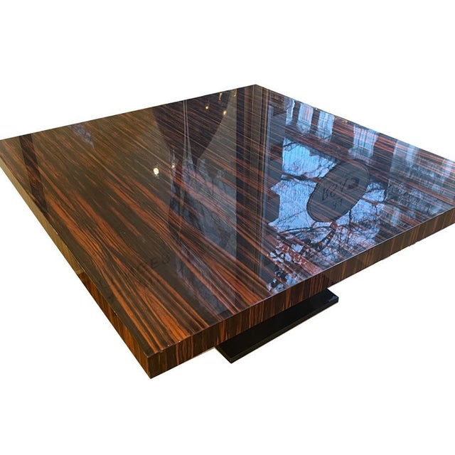 Large square Art Deco coffee table France around 1930. Macassar and black lacquer. Slightly rising black mustache base...