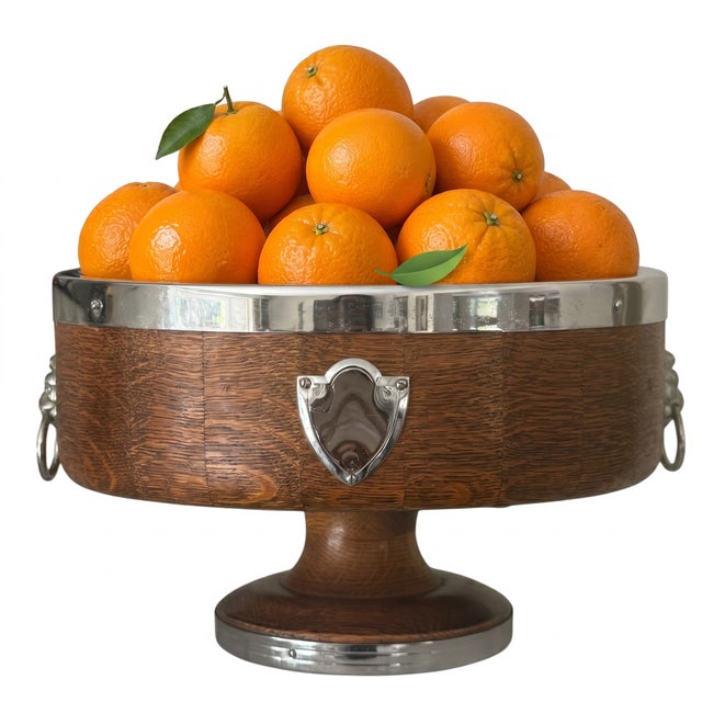 An elegant vintage pedestal center bowl crafted in richly figured quarter-sawn oak and accented with polished nickel-...