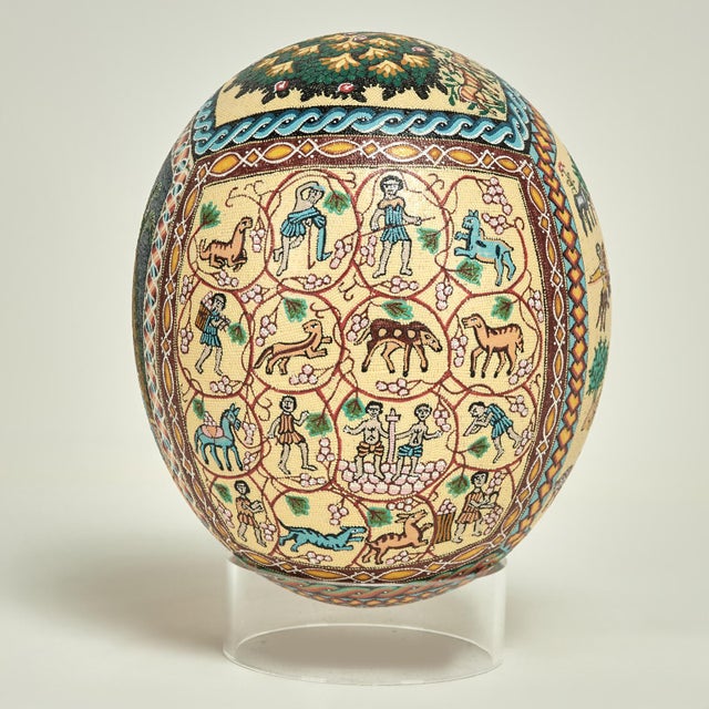 Transporting vintage Moroccan ostrich egg hand decorated with figures, animals and trees executed in classic Moorish style...