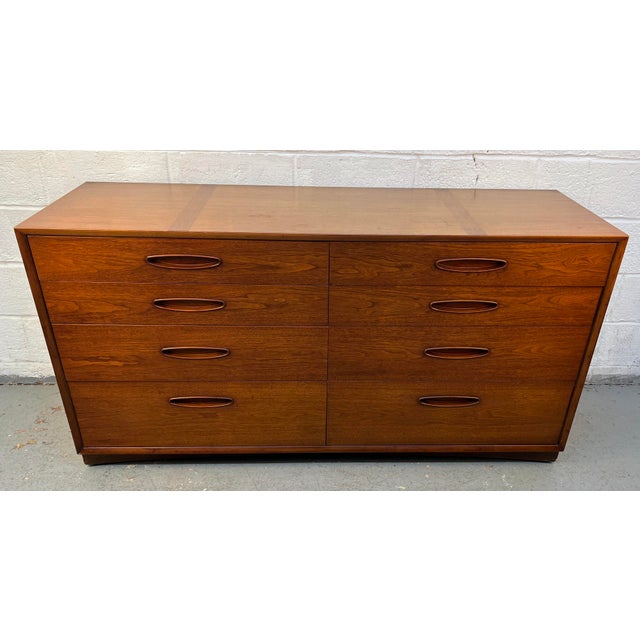 An iconic piece from Henredon's celebrated "Circa 60" collection, this mid-century modern walnut lowboy dresser...