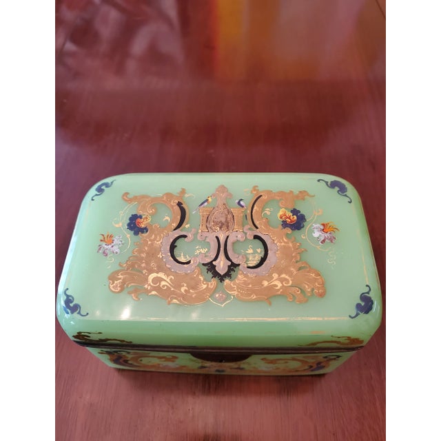 An absolute museum piece a circa 1840's jade color opaline art glass jewel box casket. Having all handpainted raised 24k...