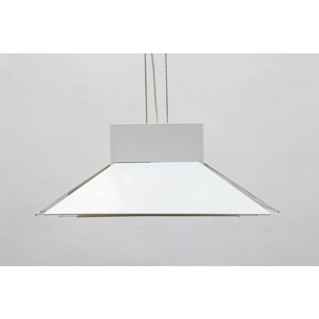 A multi-layered metal pendant light varnished in white, in very good, used condition. 1980s, Denmark. No dents, no...
