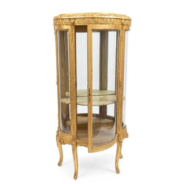 The piece is highly ornate, featuring intricate classical carvings along the top frieze and frame moldings, mirroring late...