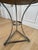 French mid-century guéridon side table featuring a sculptural hand-forged silver iron base with original aged zinc-washed...