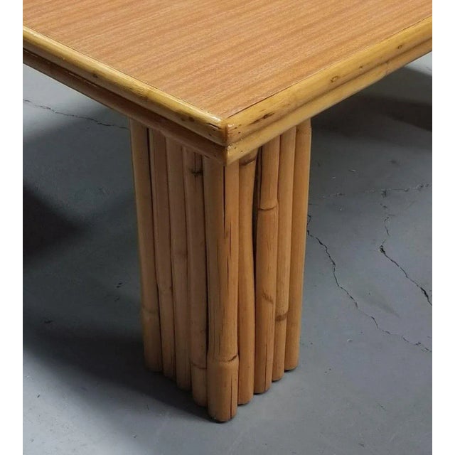 Extra wide 36" square coffee table with 9-strand vertically stacked rattan legs and a Formica wood grain pattern top with...