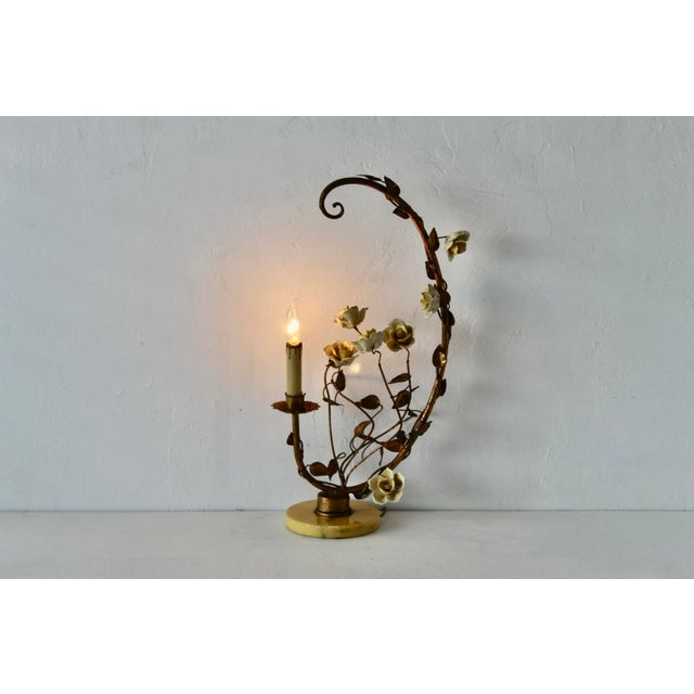 A fabulous vintage mid-century gilded tole yellow porcelain roses table lamp featuring a graceful metal vine structure...