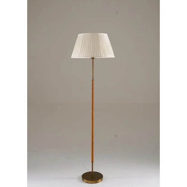 Scandinavian floor lamp, manufactured by Böhlmarks in Sweden during the 1950s. This high-quality piece showcases the...