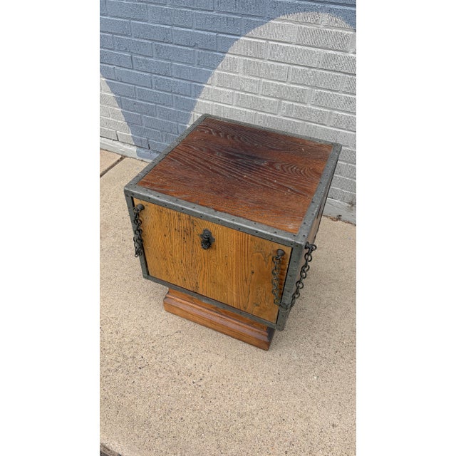 A striking medieval-style cabinet table, evocative of Gothic Revival design, combining rustic character with architectural...