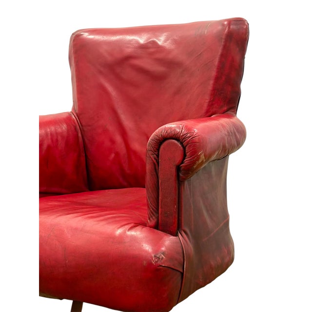 English Swivel Club Armchair Circa 1900, made of Moroccan red leather, oak wood legs and brass wheels.