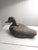 Here a primitive duck decoy that has aged through time and usage. From it's hand painted eyes to it's cork body, it exudes...