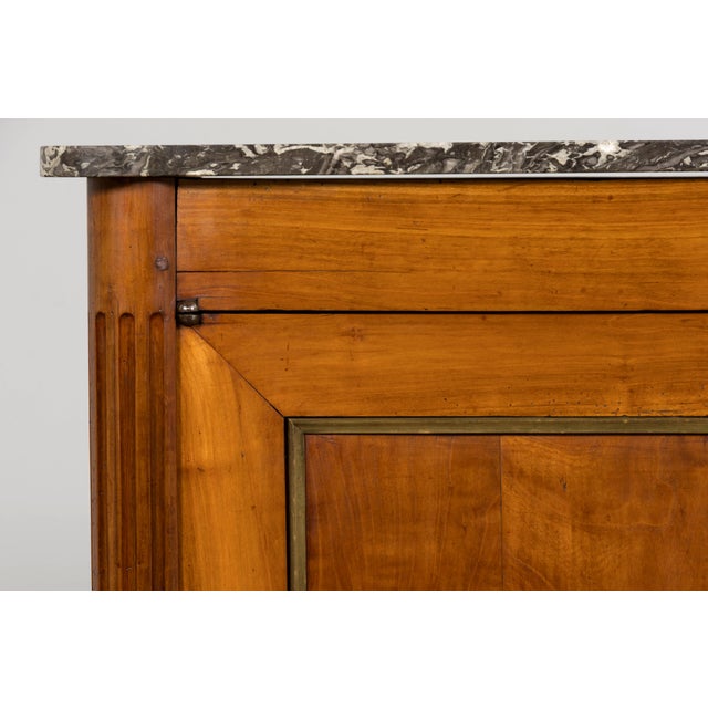 Sourced from Provence, France, this early 19th century French Louis XVI buffet is crafted in richly figured walnut and...