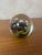 Sulfide/paperweight in clear, spherical blown glass. This piece features a dynamic internal inclusion with bursts of vivid...