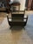 Metal firewood storage basket in designer Jansen style with brass caps to a grey steel metal body. Measures 16” tall, 16”...
