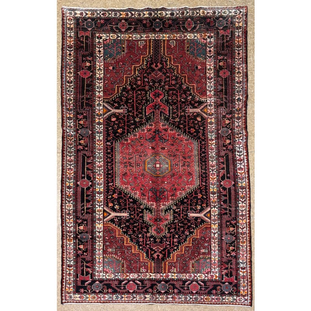Antique hand-knotted rug from the Tuyserkan (Toeiserkan) region of western Iran, featuring a large central hexagonal...
