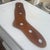 The object is a vintage wooden sock stretcher (also called a sock form or dryer), traditionally used to shape and dry...