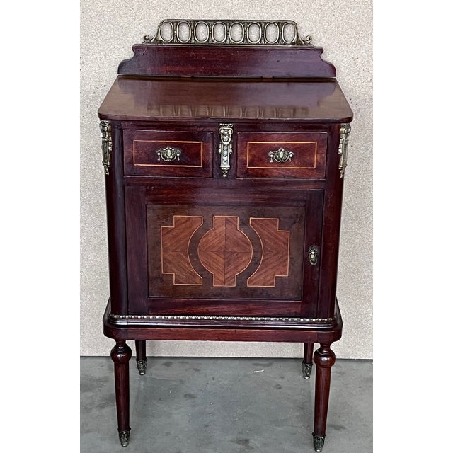 Pair of Italian Marquetry Nightstands with Bronze Crest, drawers and doors. Little drawers in higher part and door. Both...