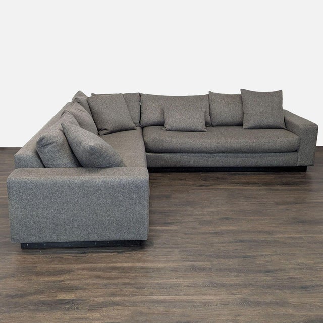 This spacious sectional by Rene Cazares features a stylish gray fabric and a modern design. The sofa includes wide...