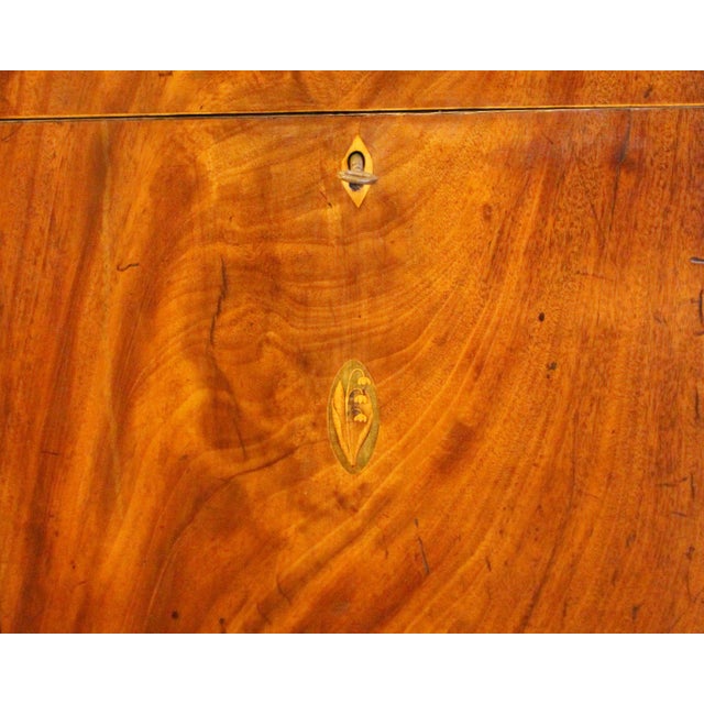 Circa 1800 George III cellarette side table, English. Flame mahogany veneers, quarter paterae corner inlays, lilly of the...