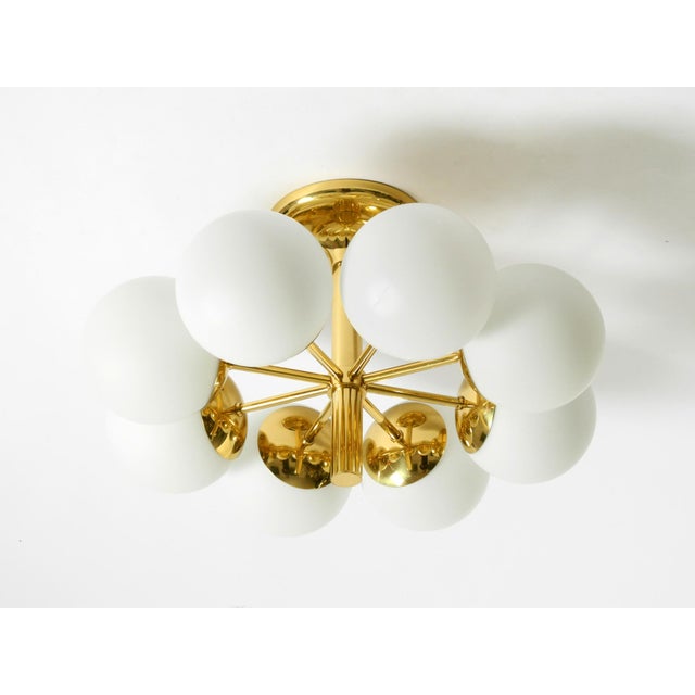 Beautiful brass ceiling light from 1960 with 8 white opal glass balls. manufacturer is kaiser leuchten. Made in germany....